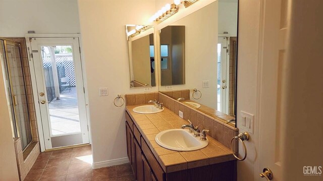 6307 San Rogue Ct, Bakersfield, CA 93312 - full bath with double vanity, a shower with door, baseboards, and tile patterned floors
