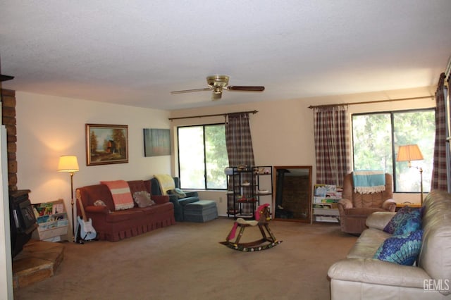 living room with carpet flooring, ceiling fan, and a healthy amount of sunlight