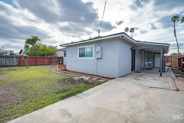 1800 Hughes Ln, Bakersfield, CA 93304 - view of side of home featuring a patio area and stucco siding