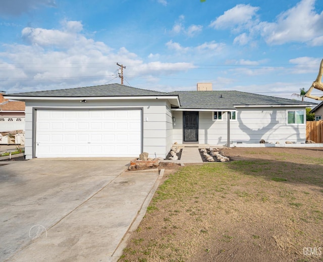 1800 Hughes Ln, Bakersfield, CA 93304 - ranch-style house with concrete driveway, an attached garage, and roof with shingles
