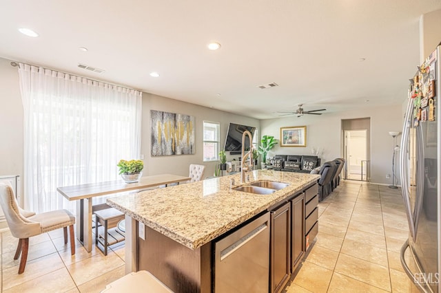 3647 Monument Hills Ave, Rosamond, CA 93560 - kitchen with stainless steel appliances, light tile patterned floors, an island with sink, recessed lighting, and ceiling fan
