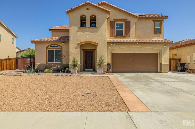 3647 Monument Hills Ave, Rosamond, CA 93560 - mediterranean / spanish home featuring a tiled roof, stucco siding, an attached garage, and concrete driveway
