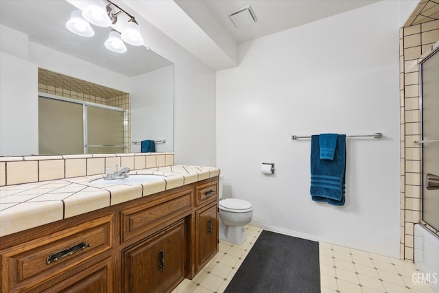 full bath featuring toilet, vanity, baseboards, visible vents, and tile patterned floors