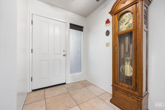 entryway featuring a textured ceiling and light tile patterned flooring