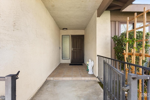 doorway to property featuring stucco siding