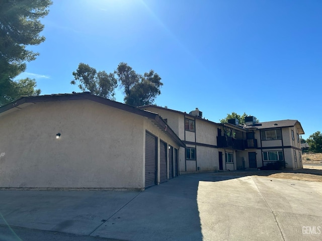 view of home's exterior with driveway, an attached garage, and stucco siding