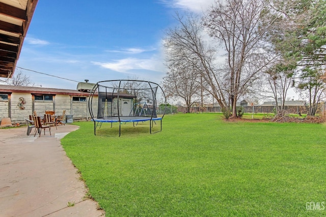 view of yard featuring a patio and a trampoline