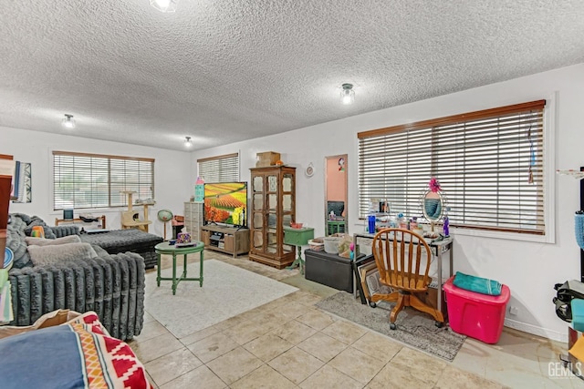 living room with a textured ceiling and light tile patterned flooring