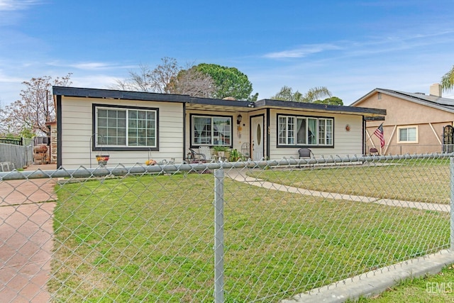 ranch-style home with a front lawn