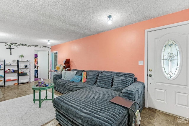 living room with a textured ceiling and tile patterned floors