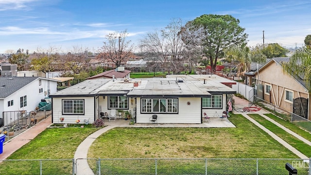 view of front of home featuring solar panels, a patio, and a front lawn