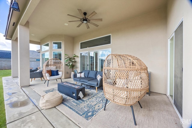 view of patio with a ceiling fan and an outdoor living space with a fire pit