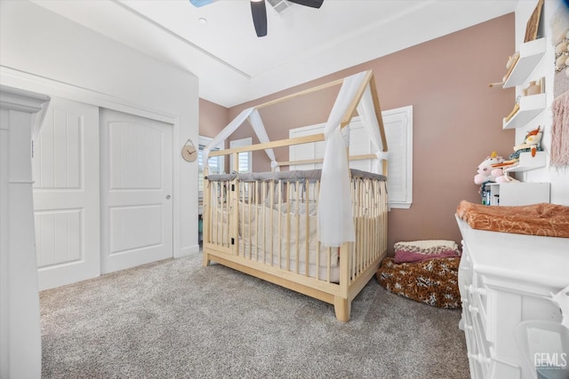 bedroom with carpet floors, ceiling fan, and a closet