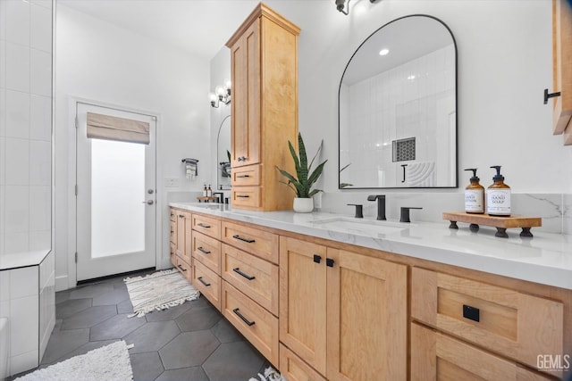 full bathroom featuring tile patterned flooring, walk in shower, a sink, and double vanity