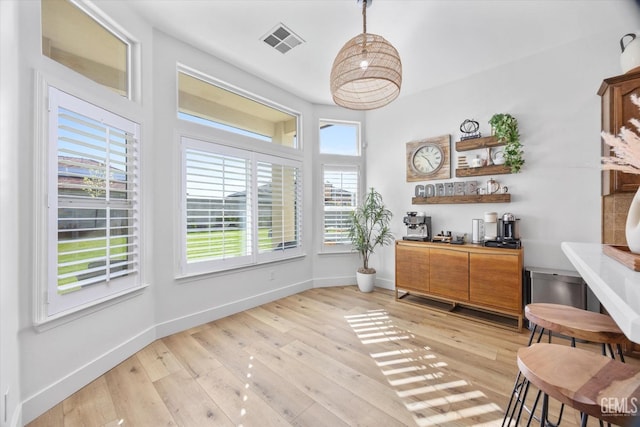 interior space with light wood-style flooring, visible vents, and baseboards