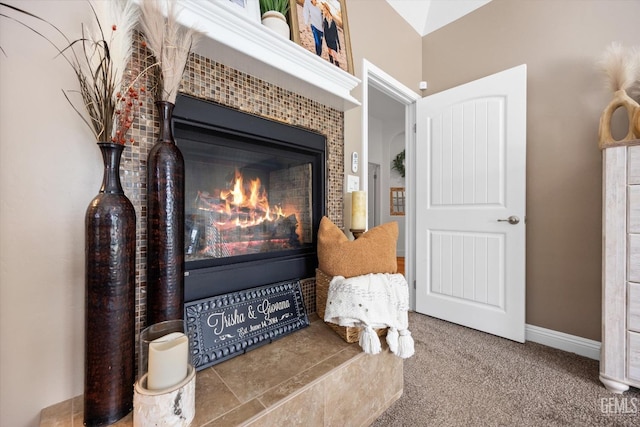 interior details with carpet flooring, a fireplace, and baseboards