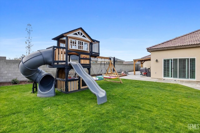 view of playground featuring a patio area, a yard, and a fenced backyard