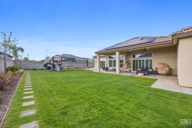 view of yard with a playground, a patio, and a fenced backyard