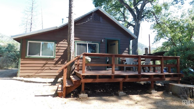 back of house with a wooden deck