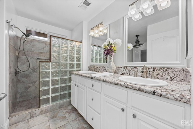 bathroom featuring a sink, visible vents, and a healthy amount of sunlight