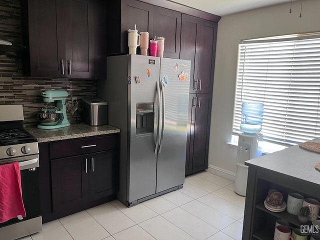 6009 Georgia Pine Way, Bakersfield, CA 93313 - kitchen with stainless steel appliances, light tile patterned flooring, backsplash, and light stone countertops