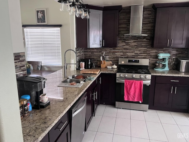 6009 Georgia Pine Way, Bakersfield, CA 93313 - kitchen featuring appliances with stainless steel finishes, wall chimney exhaust hood, tasteful backsplash, light tile patterned floors, and light stone counters