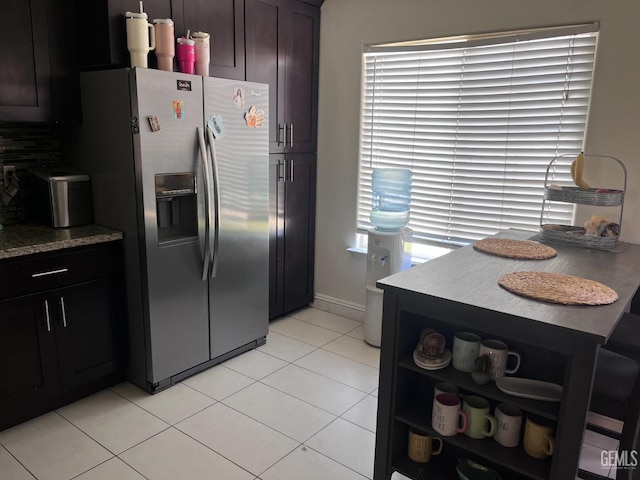 6009 Georgia Pine Way, Bakersfield, CA 93313 - kitchen featuring stainless steel refrigerator with ice dispenser, light tile patterned flooring, dark brown cabinetry, light countertops, and open shelves