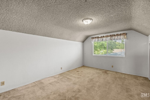 bonus room with a textured ceiling, carpet, and lofted ceiling