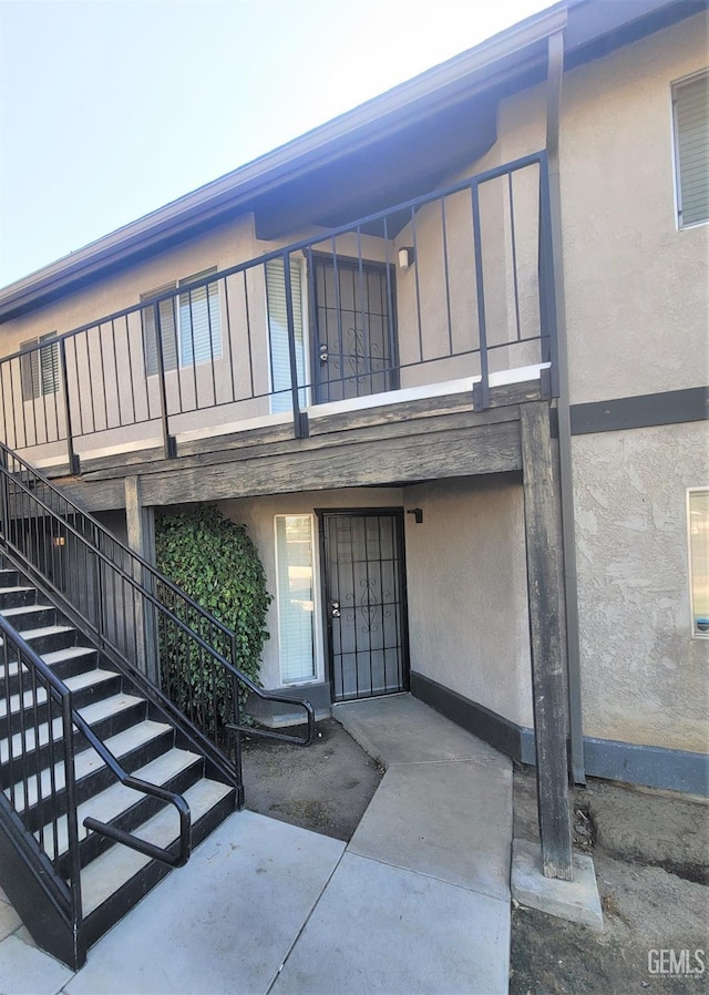 entrance to property with stucco siding