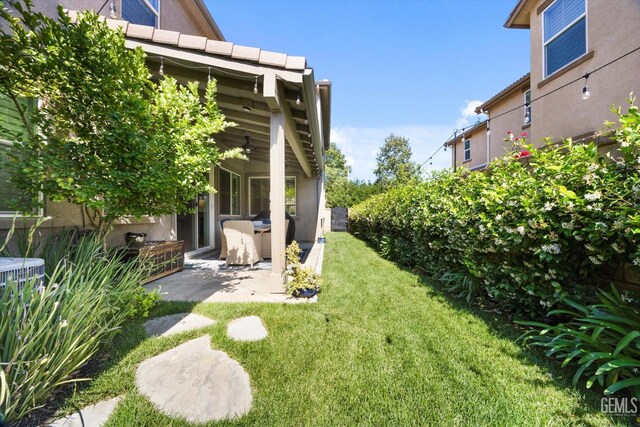 28537 Vista Del Rio Dr, Valencia, CA 91354 - view of green lawn with a patio area and a ceiling fan