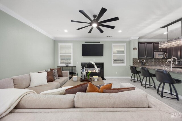 28537 Vista Del Rio Dr, Valencia, CA 91354 - living room featuring a glass covered fireplace, ceiling fan, recessed lighting, and ornamental molding