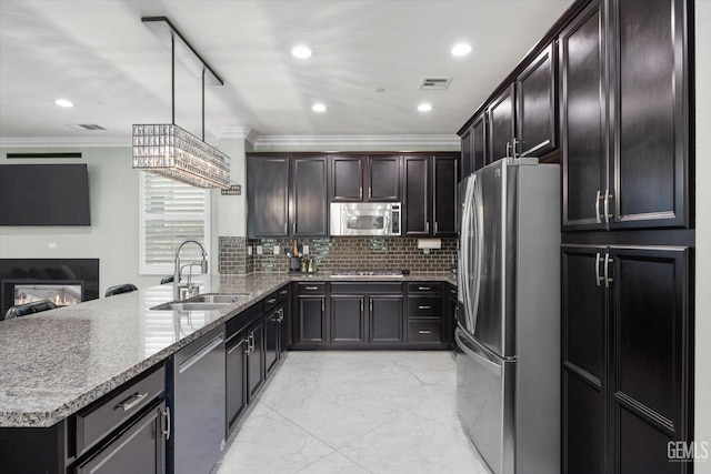 28537 Vista Del Rio Dr, Valencia, CA 91354 - kitchen featuring stainless steel appliances, ornamental molding, a peninsula, light stone counters, and light marble finish flooring
