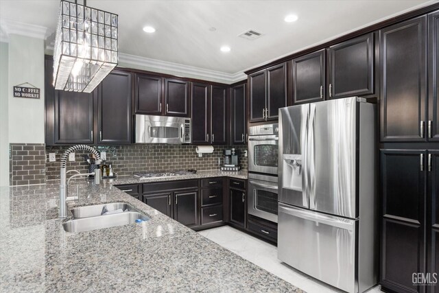 28537 Vista Del Rio Dr, Valencia, CA 91354 - kitchen featuring stainless steel appliances, light stone countertops, ornamental molding, decorative backsplash, and hanging light fixtures