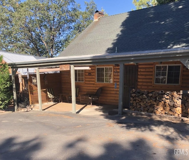 45796 Carlin Dr, Posey, CA 93260 - back of property featuring a chimney, faux log siding, and a patio