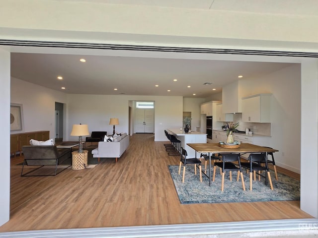 dining area with recessed lighting, baseboards, and light wood-style floors