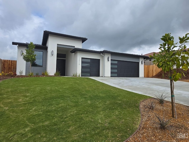 12110 Pendulum Dr, Bakersfield, CA 93306 - view of front of property with concrete driveway, fence, a garage, and a front lawn