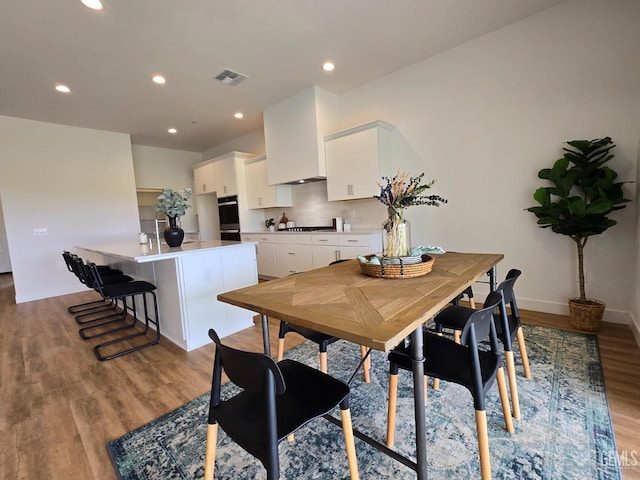 dining space with recessed lighting, visible vents, baseboards, and light wood-style flooring