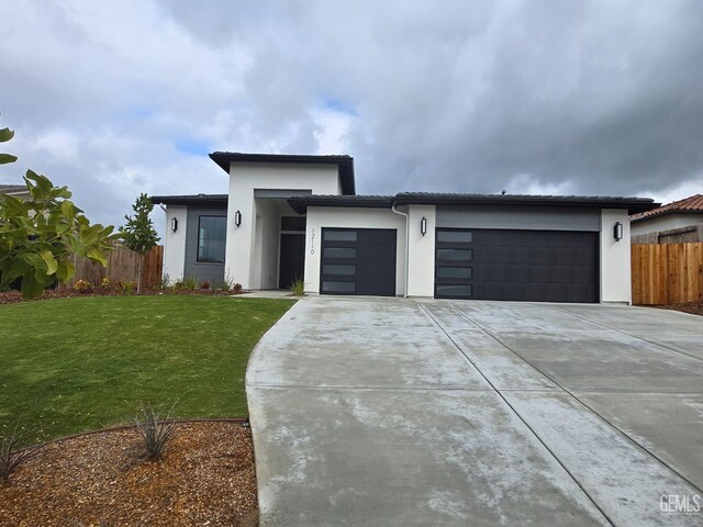 12110 Pendulum Dr, Bakersfield, CA 93306 - view of front of house with a front yard, fence, a garage, and driveway