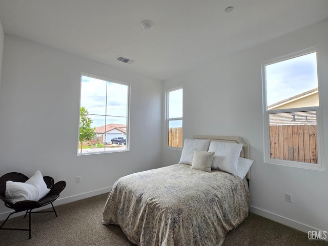 bedroom with carpet, visible vents, and baseboards