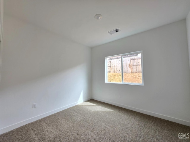 unfurnished room featuring visible vents, baseboards, and carpet