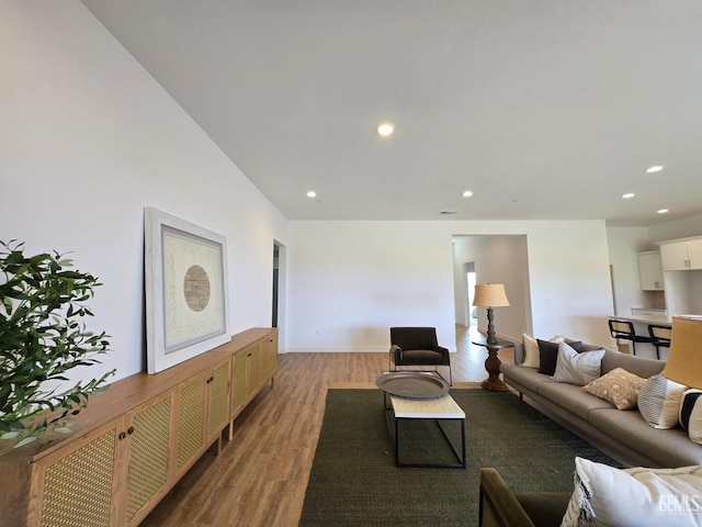 living room featuring light wood finished floors, visible vents, and recessed lighting