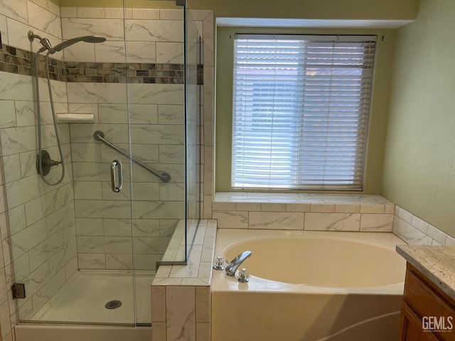 7412 Indian Gulch St, Bakersfield, CA 93313 - bathroom featuring a garden tub, a stall shower, and vanity