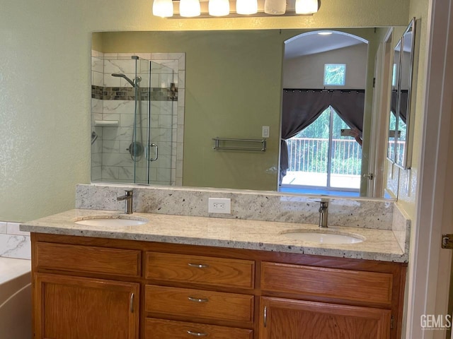 7412 Indian Gulch St, Bakersfield, CA 93313 - bathroom featuring double vanity, a shower stall, a textured wall, and a bath