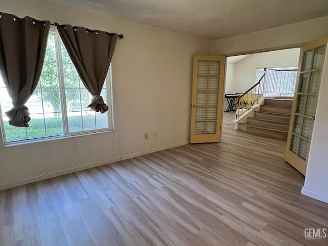 7412 Indian Gulch St, Bakersfield, CA 93313 - empty room featuring wood finished floors, plenty of natural light, and stairs