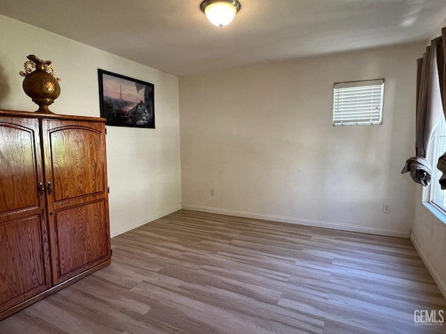 7412 Indian Gulch St, Bakersfield, CA 93313 - unfurnished bedroom with wood finished floors and multiple windows