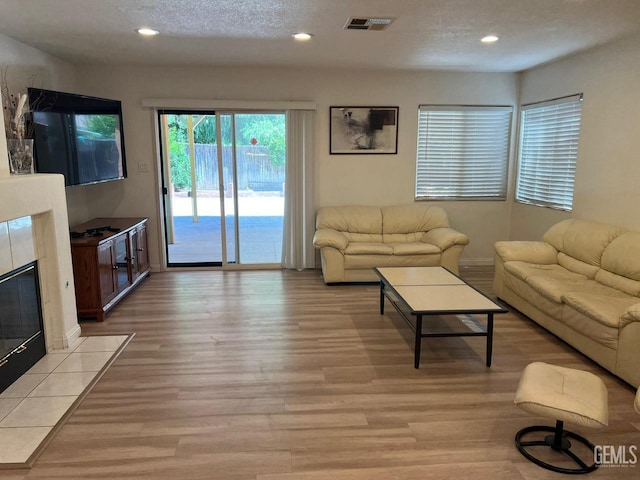 7412 Indian Gulch St, Bakersfield, CA 93313 - living area with light wood-type flooring, recessed lighting, and a fireplace
