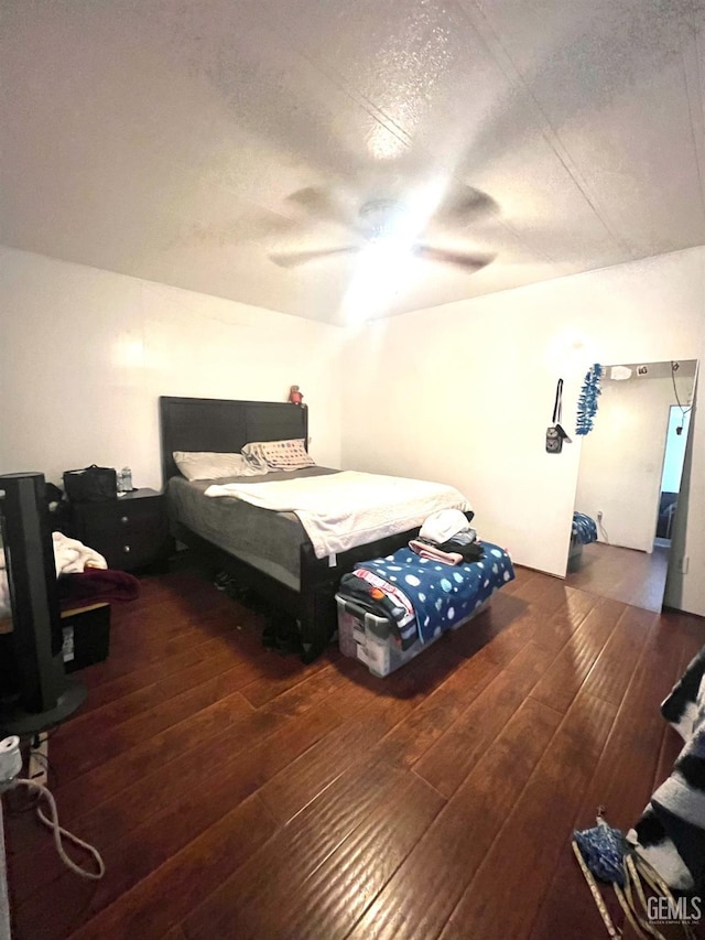 bedroom featuring hardwood / wood-style floors and a ceiling fan