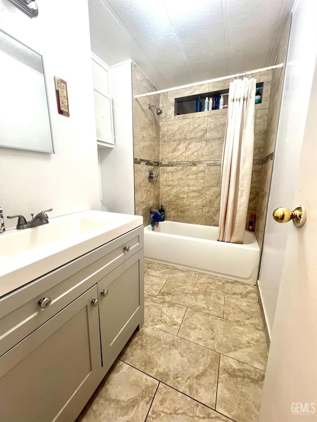 bathroom with shower / bath combo, a textured ceiling, and vanity