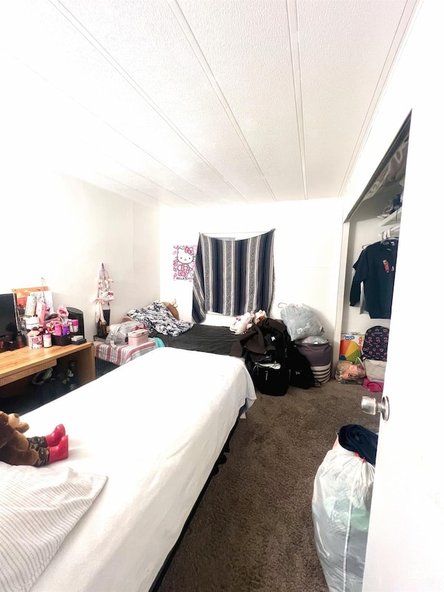 carpeted bedroom with a textured ceiling