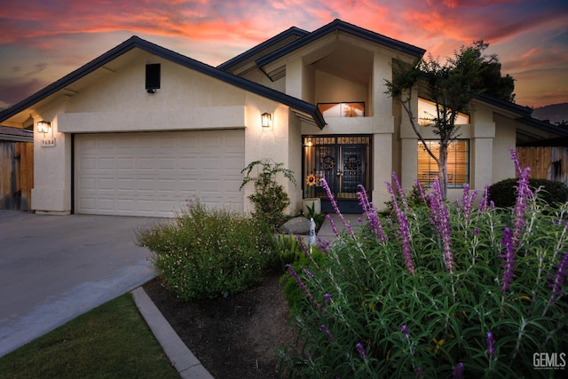 9604 Lea Oak Rd, Bakersfield, CA 93311 - view of front of house with stucco siding, concrete driveway, and an attached garage